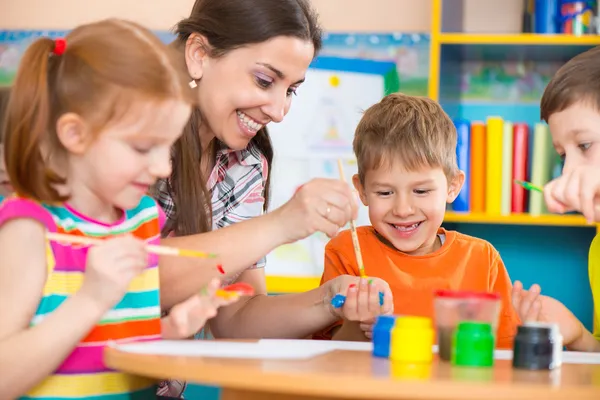 depositphotos_46644109 stock photo cute children drawing with teacher